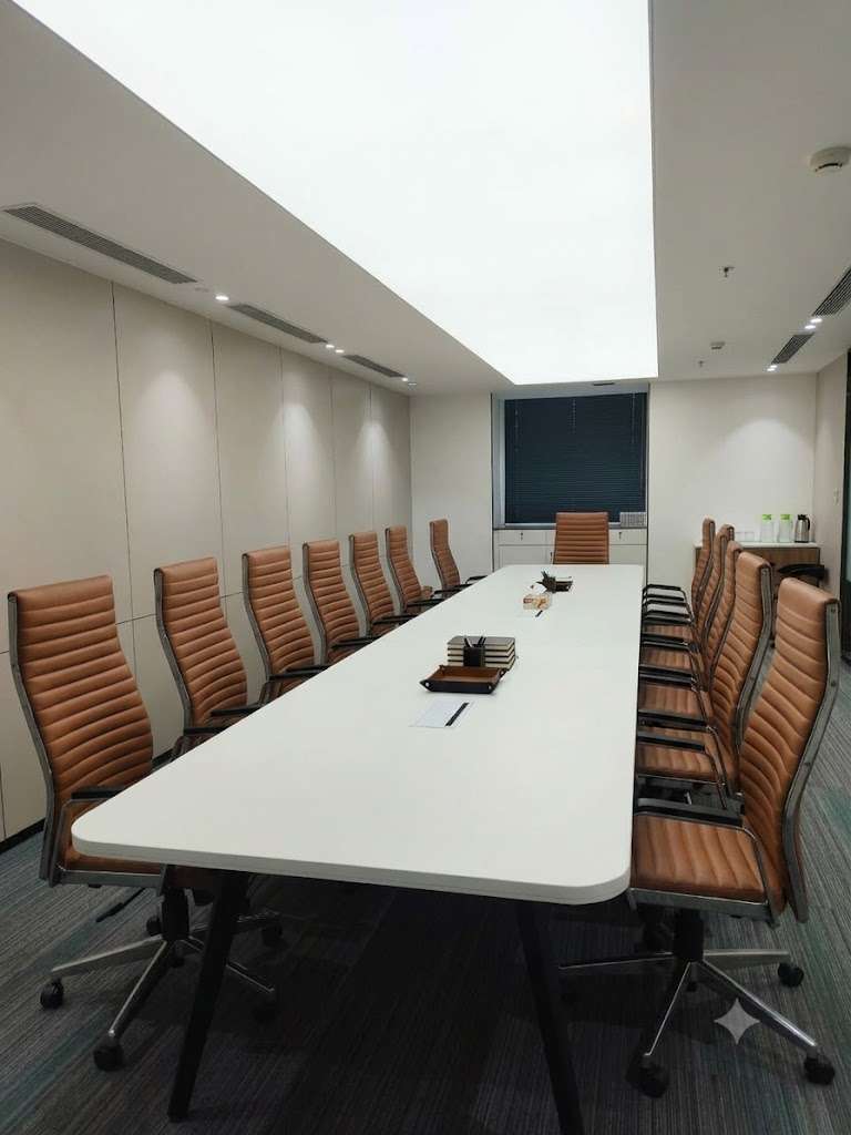 Zydus Wellness conference room with long central table, ergonomic seating and linear ceiling lighting